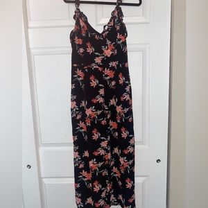 Black floral jumper with ruffles on the shoulders and around the front and back